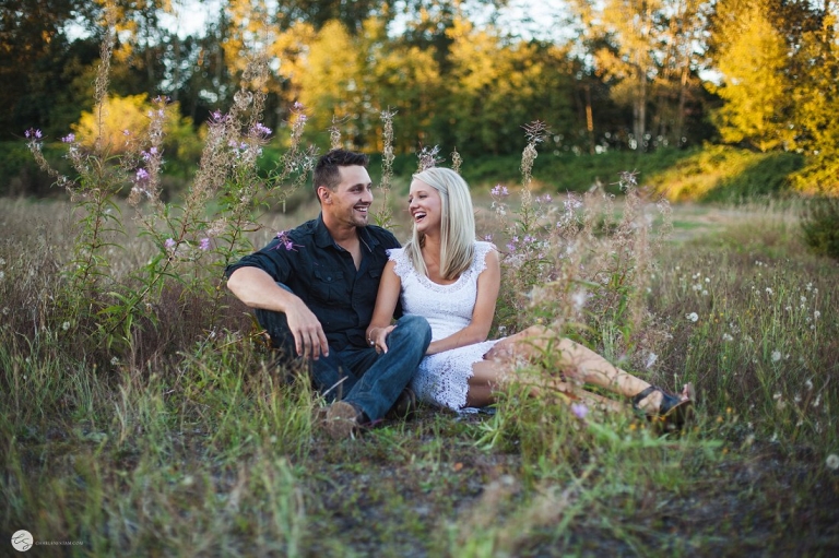 couple sitting in grass laughing