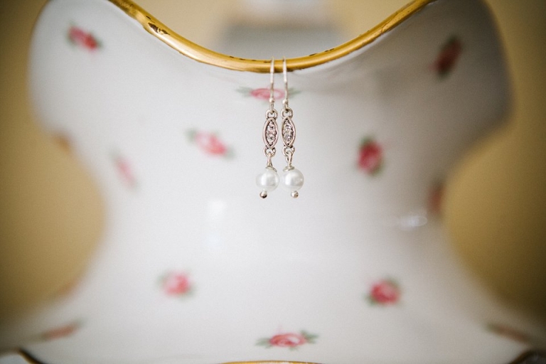earrings hanging on china pitcher