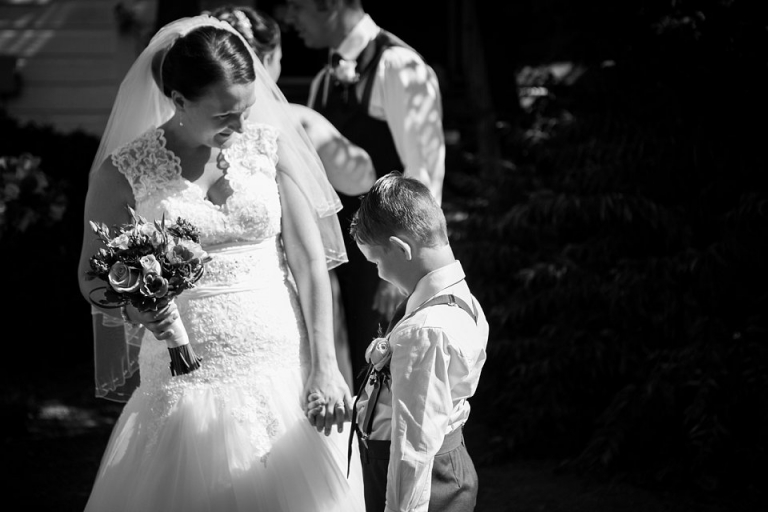bride sharing a moment with her son on her wedding day