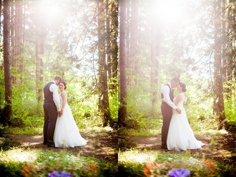 black and white photo of bride and groom kissing in forest