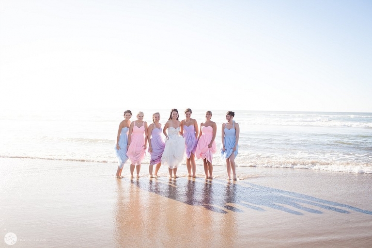 bridesmaids standing in the ocean