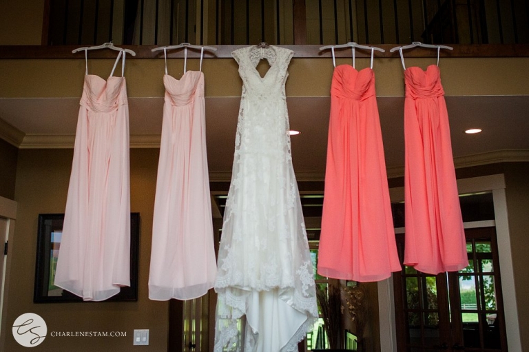 bride and bridesmaid dress hanging from stair railing