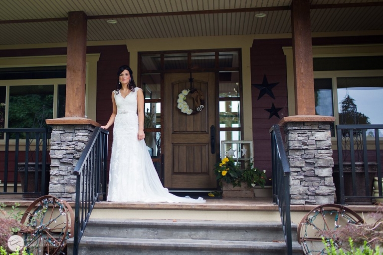 bride standing on the front steps of her house