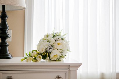 bridal bouquet in front of white curtains