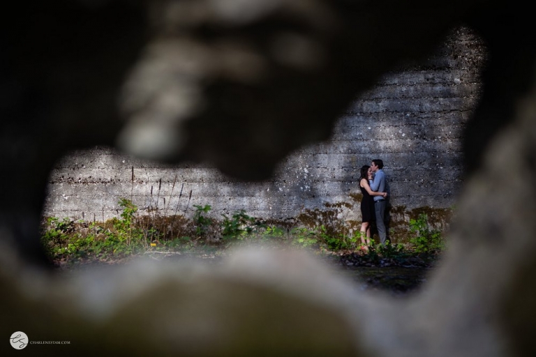 picture of a couple through a hole in the wall