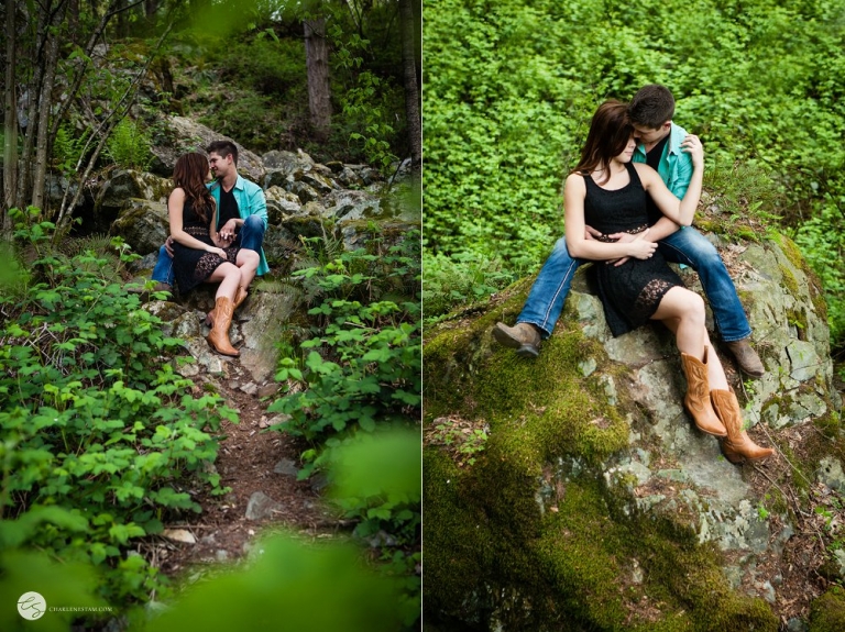 engaged couple snuggling in the forest