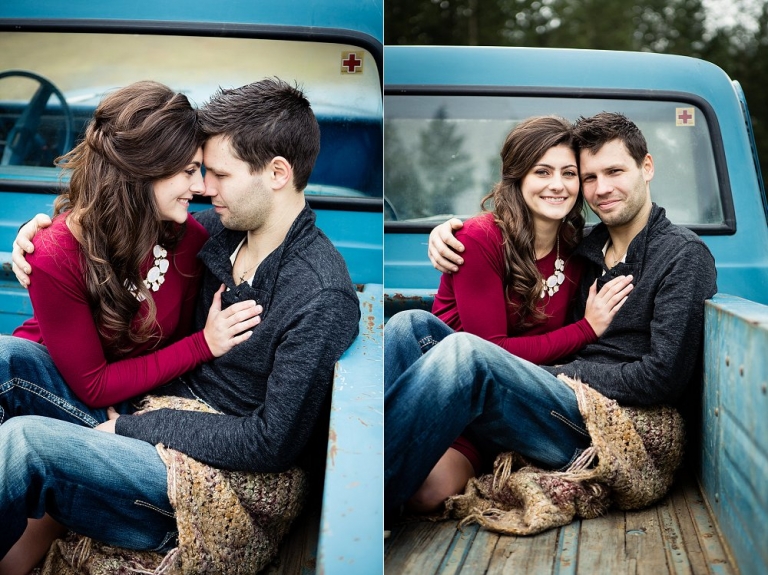 engaged couple snuggling in the box of an old chevrolet truck