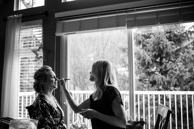 bride having her makeup done on her wedding day