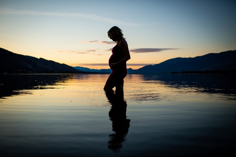 silouhette of a pregnant woman against osoyoos lake backdrop