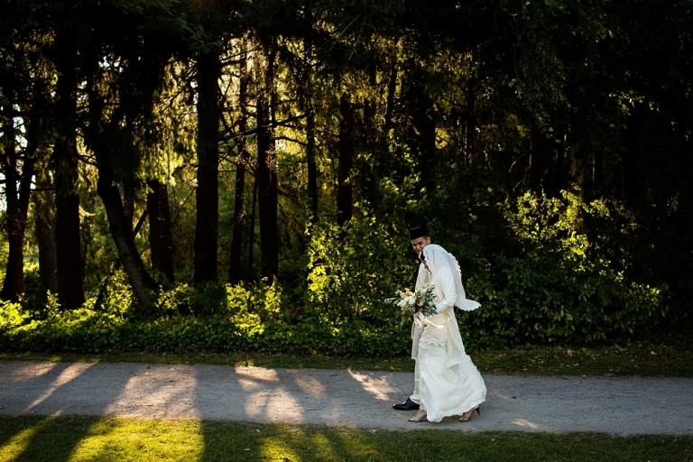 bride and groom walking down a path at the Hart House Restaurant in Buranaby