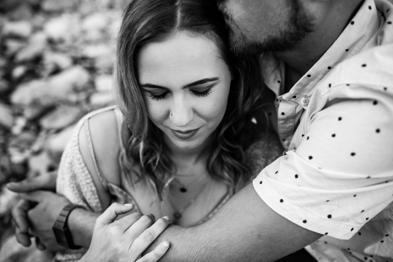 black and white photo of a guy hugging and holding a girl