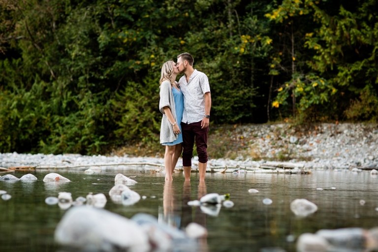 engaged couple standing in creek in mission bc