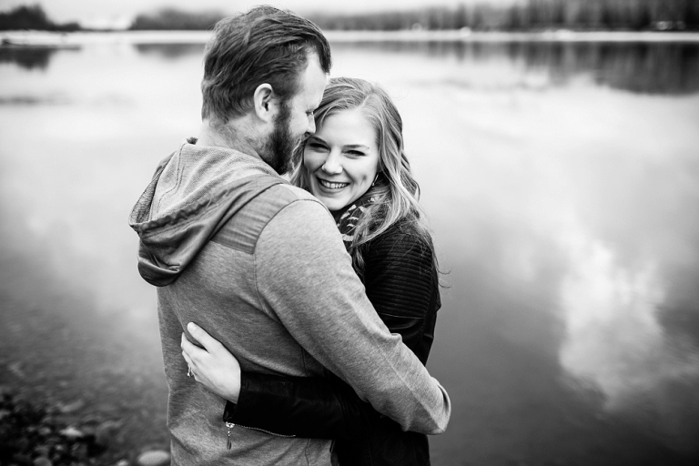 black and white photo of engaged couple hugging
